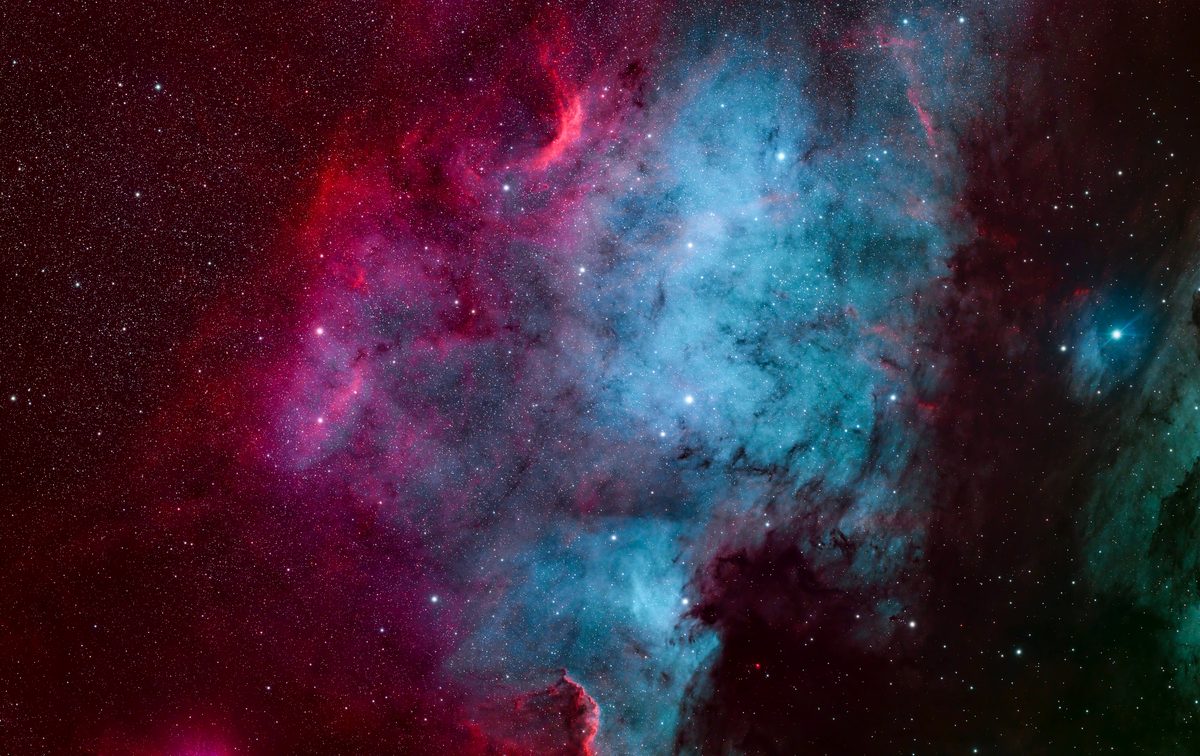 The North America Nebula, NGC 7000, in progress — crimson ionization fronts over a deep teal body of oxygen emission, imaged at Alligator View Observatory